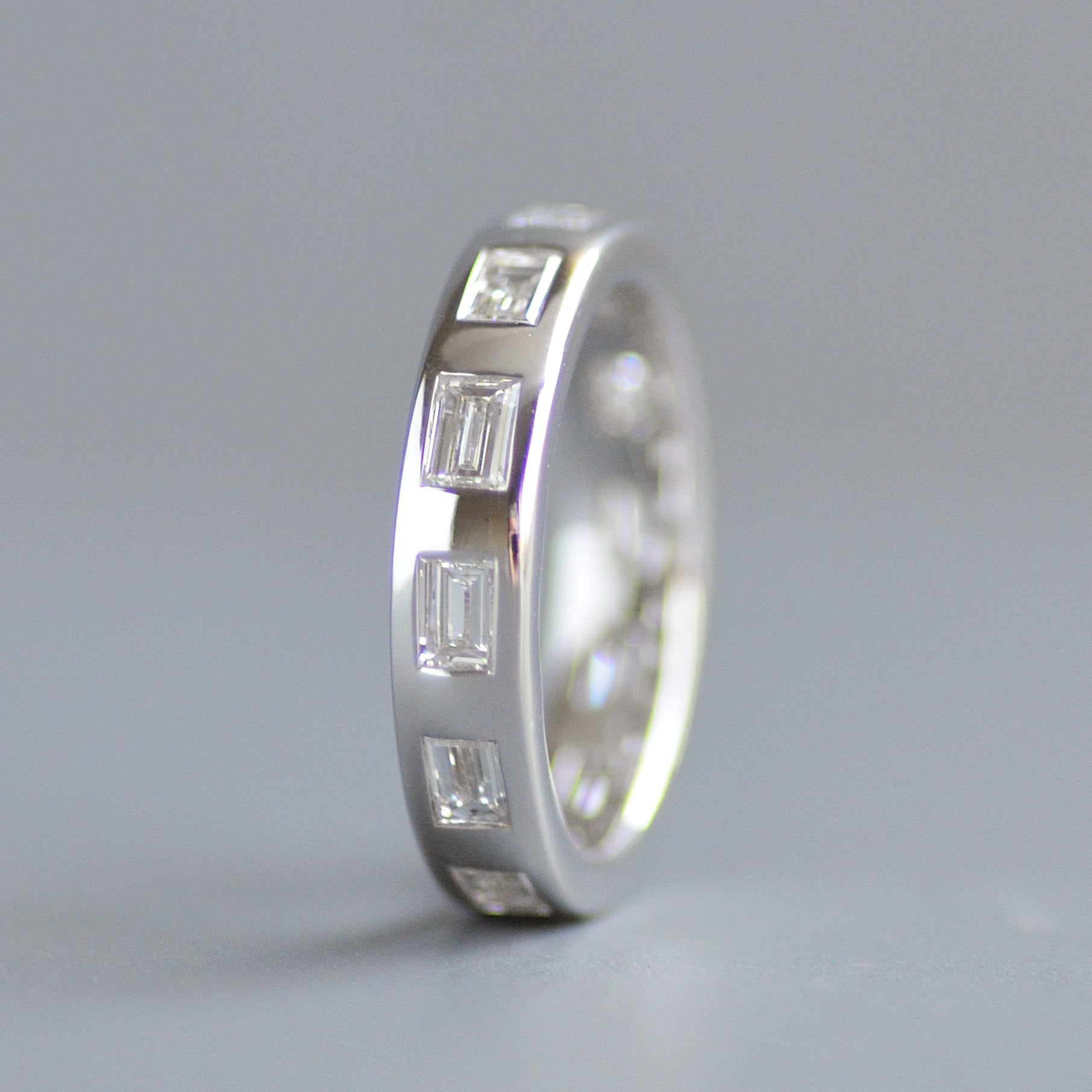 Wide emerald cut eternity band
