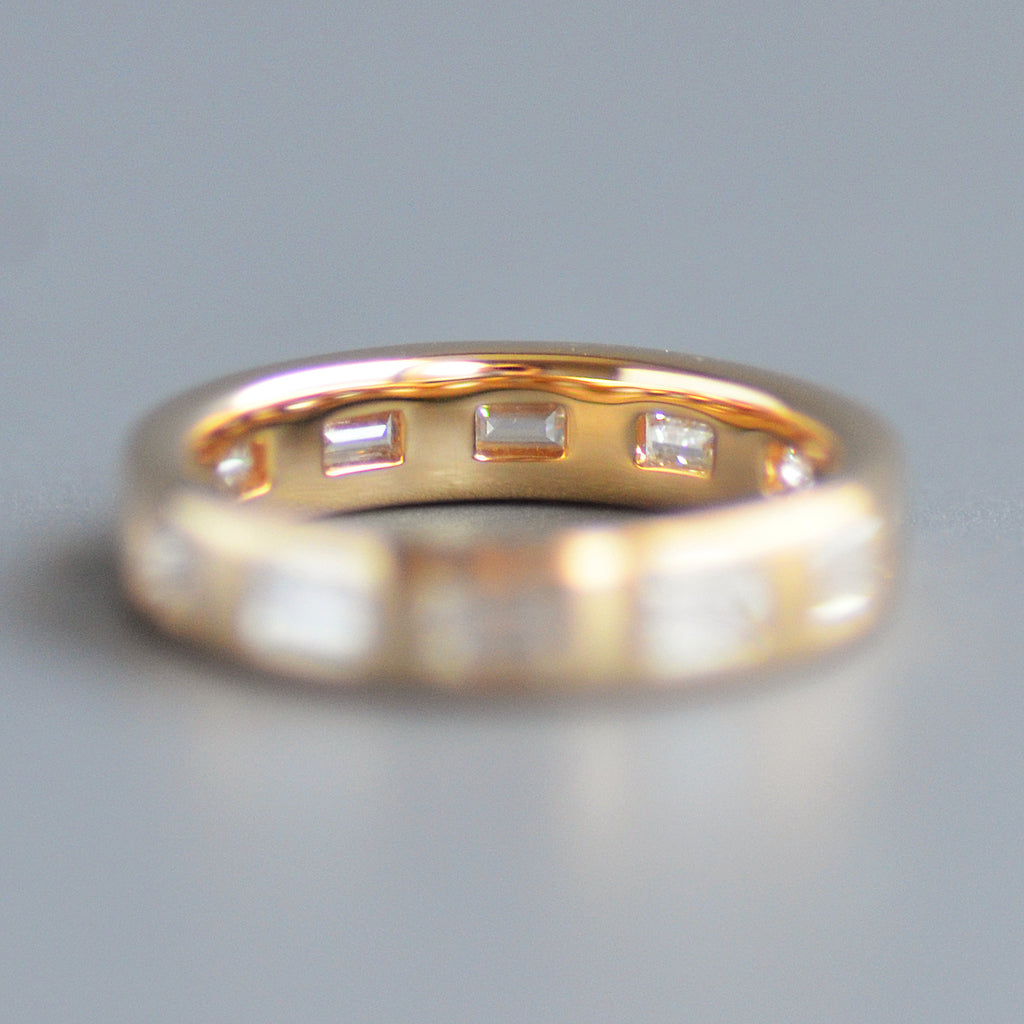 Wide emerald cut eternity band